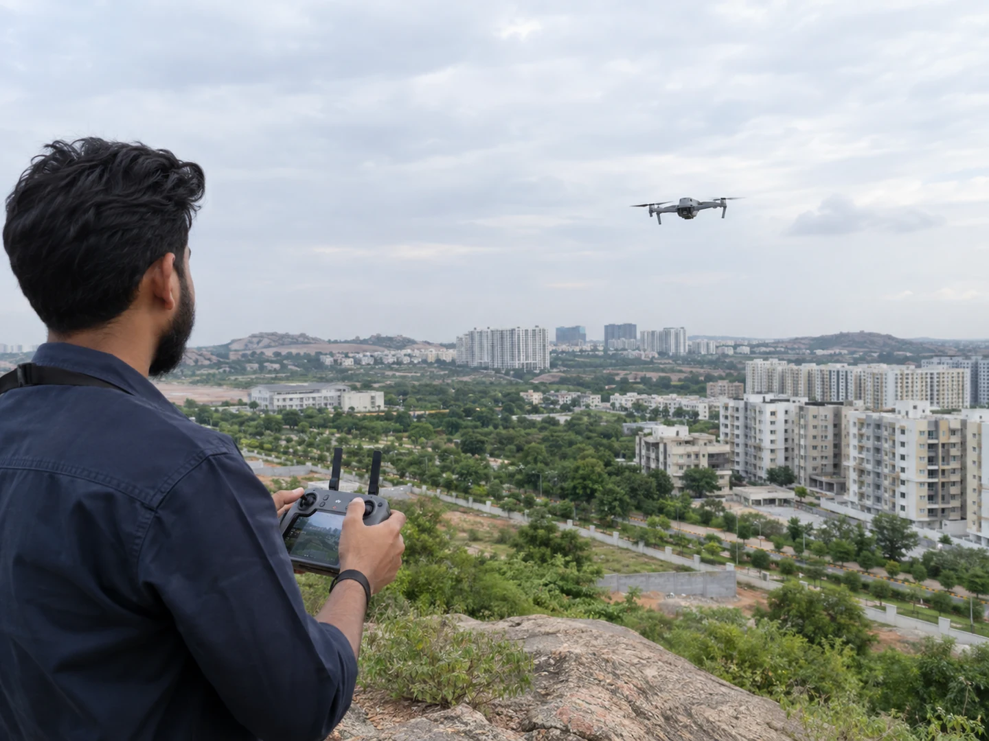 Illustrative drone operator capturing aerial content above a residential development